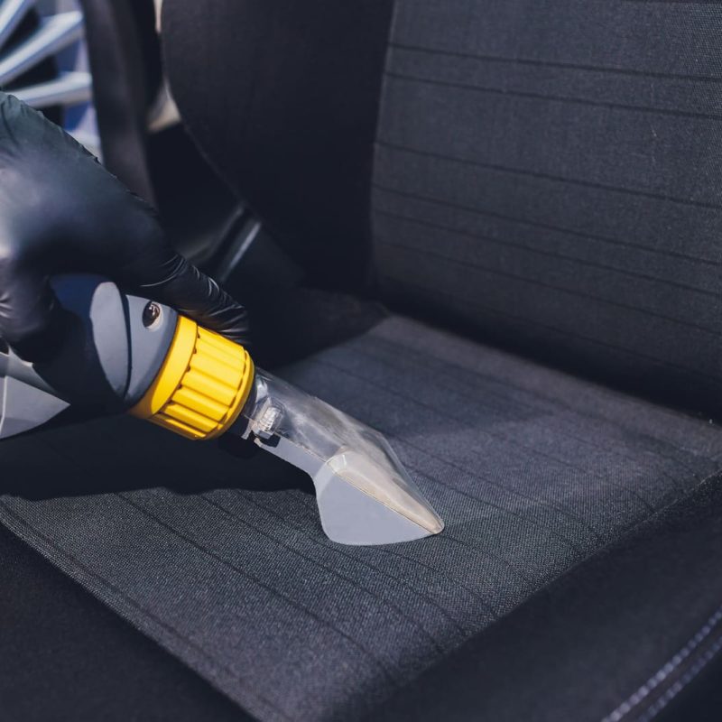 Car interior textile seats chemical cleaning with professionally extraction method. Early spring cleaning or regular clean up